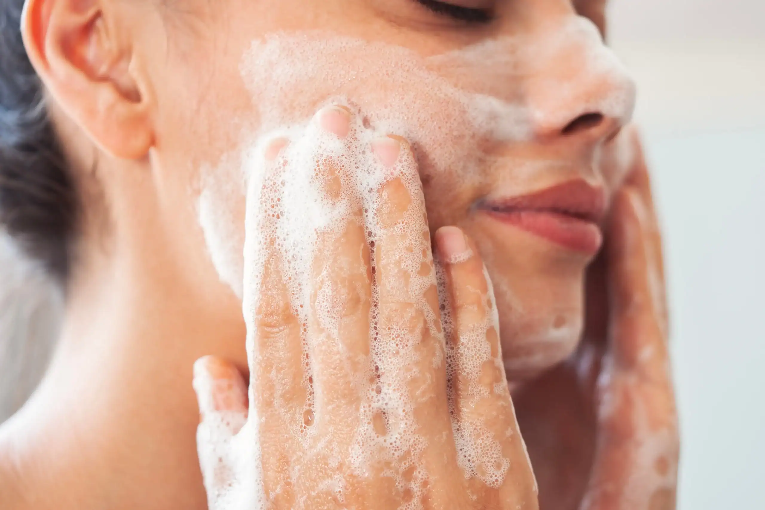 Young woman washing her face