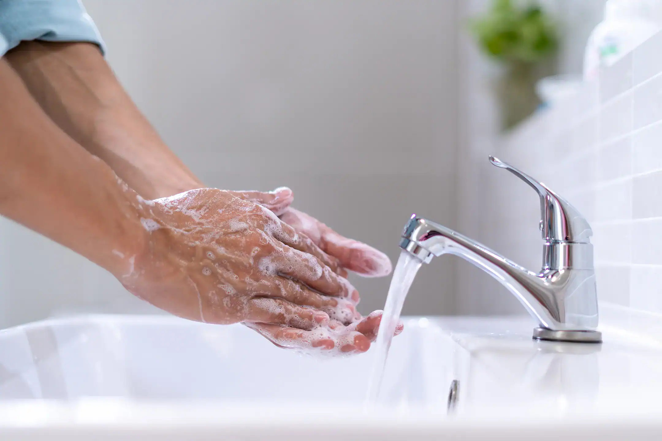 Man washes hands in skin