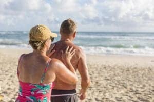 Mature couple applying sunscreen