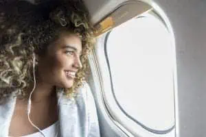 Woman on airplane next to window