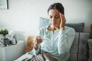 Woman checking thermometer