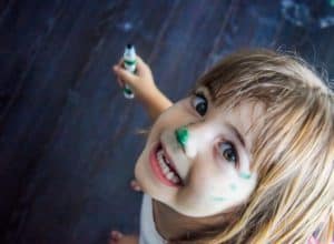 Young girl with marker on face.