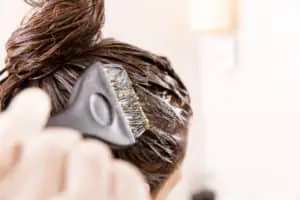 Hair dye being applied to a woman’s hair