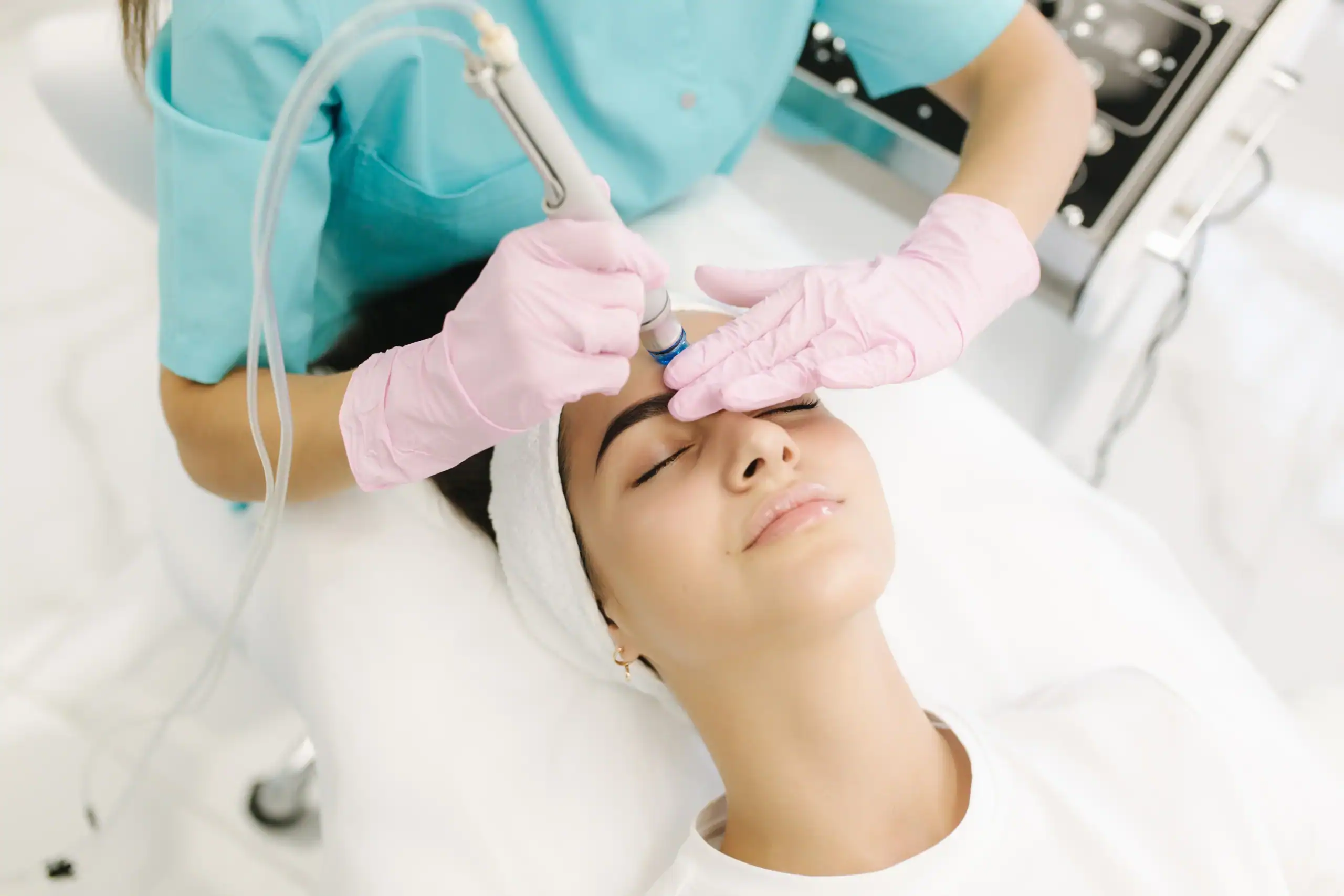 Woman in medical chair receiving facial treatment