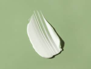 Barrier cream for dry, sensitive skin and eczema on a green background