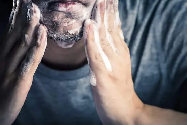 Man washing his face