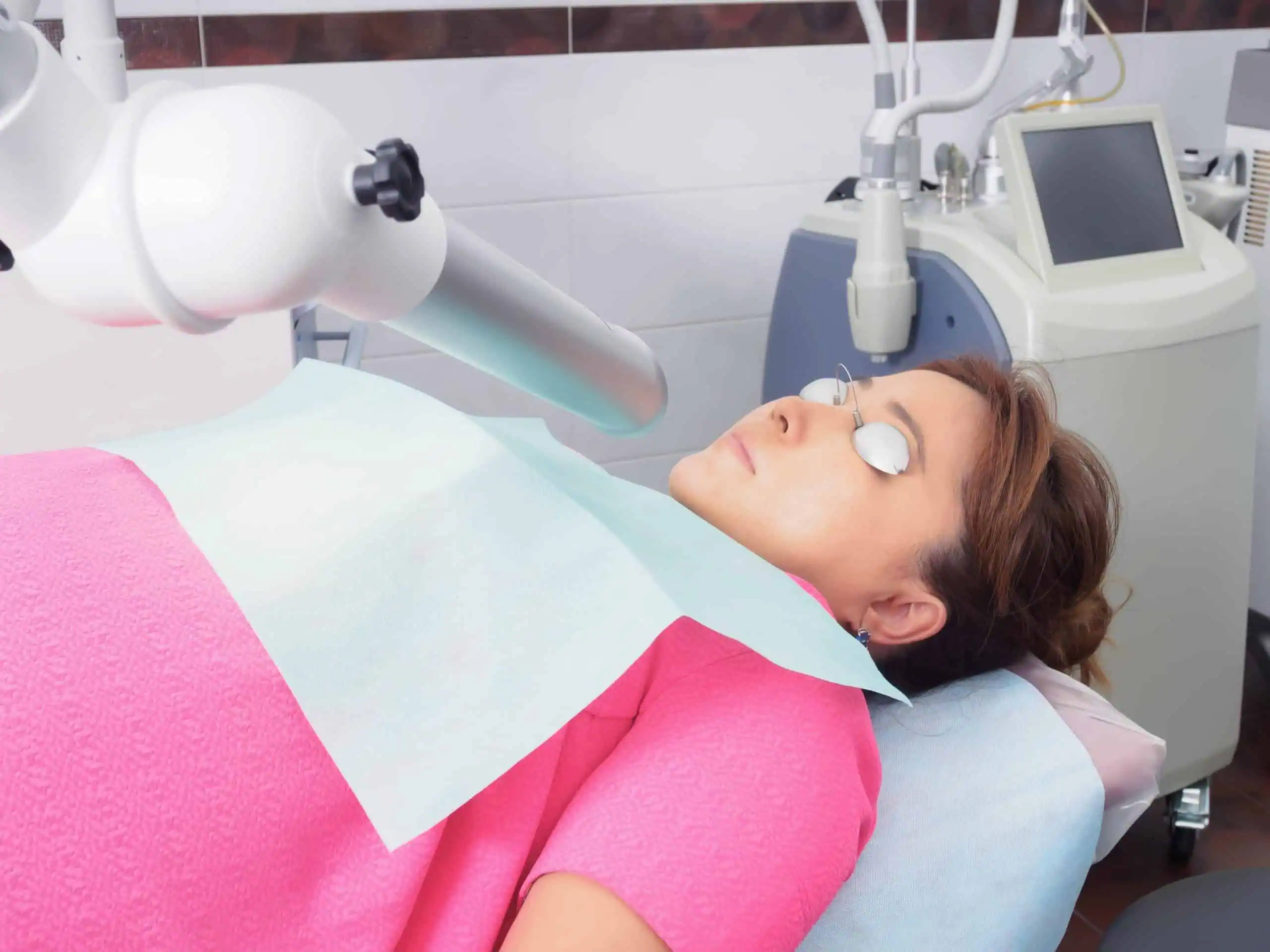 Woman in healthcare facility undergoing new acne treatments