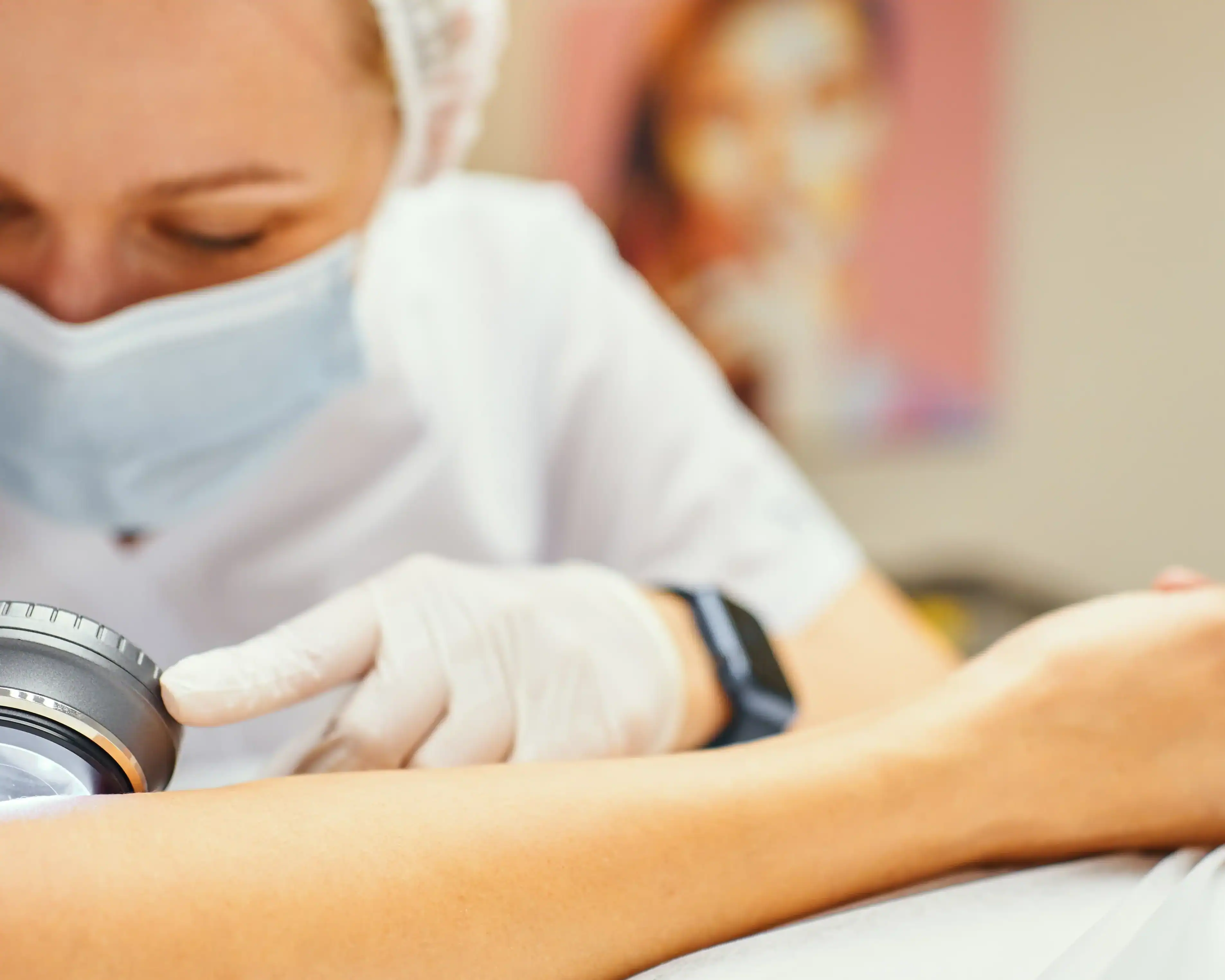 surgical dermatologist checks a patient's skin