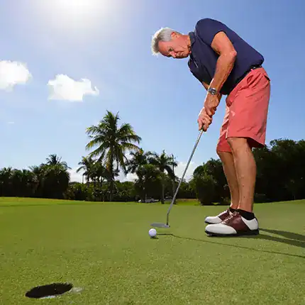 Middle-aged man plays golf on a beautiful day in Florida