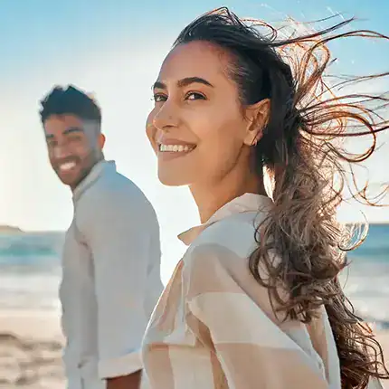 Young man and woman enjoy the beach